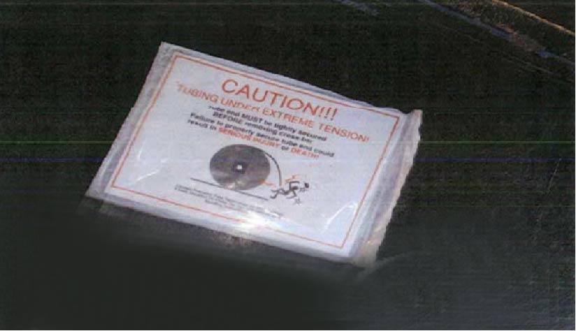 The warning label that was on the flange of the reel