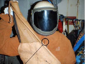 Protective clothing for rope access technicians showing small opening through which hot particle passed