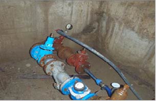 View into confined space showing water meter