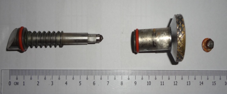 Parts of failed sealed pull pin (l-r) Plunger, with breakage point at right; knob; Nyloc lock nut