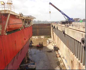 Vessel in dry dock with mobile crane