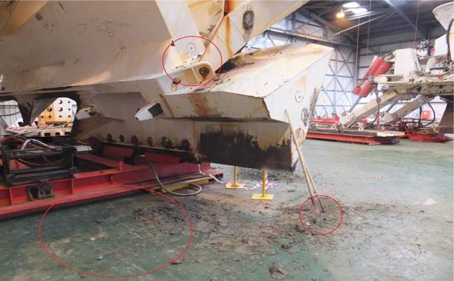 Here, the injured person was working between the ground level as well as the air skate frame (20cm high); he stepped down and slipped on the silt in the bottom of the dry dock during cleaning operations, and fell to the floor banging his head, he also cut his face and bruised his ribs and hip. Red circles indicate area being cleaned; area where injured person fell, and tools being used