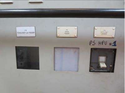 Blanks on the switchboard panel where breakers had been removed