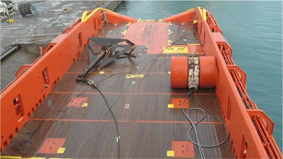 View of back deck showing Delta Flipper anchor (left), Anchor Buoy (right) and Capstan (arrow)