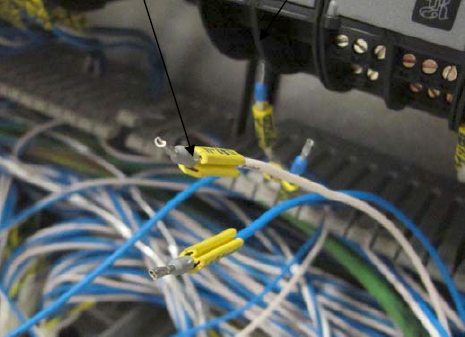 White cable that touched the electricians hand causing electric shock