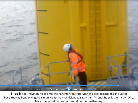 The crewman holds onto the handrail whilst the Master slowly repositions the vessel back into the boat landing; he shouts up to the technicians to stop transfer until he tells them otherwise. Note: the vessel is now not centrally on the boat landing