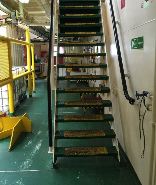 Someone was coming down these stairs when their foot slipped on the fourth step up from the main deck. This caused the person to slip down the stairs and land on their bottom on the deck bumping the left arm in the process